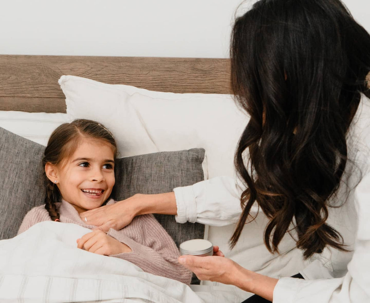 mother applies bend soap soothing salve to daughters chest